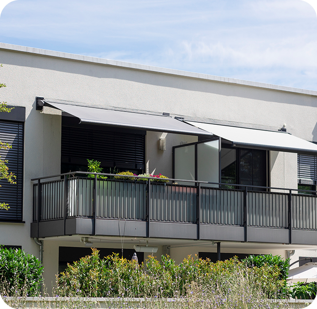 Modern balcony with plants and awnings.
