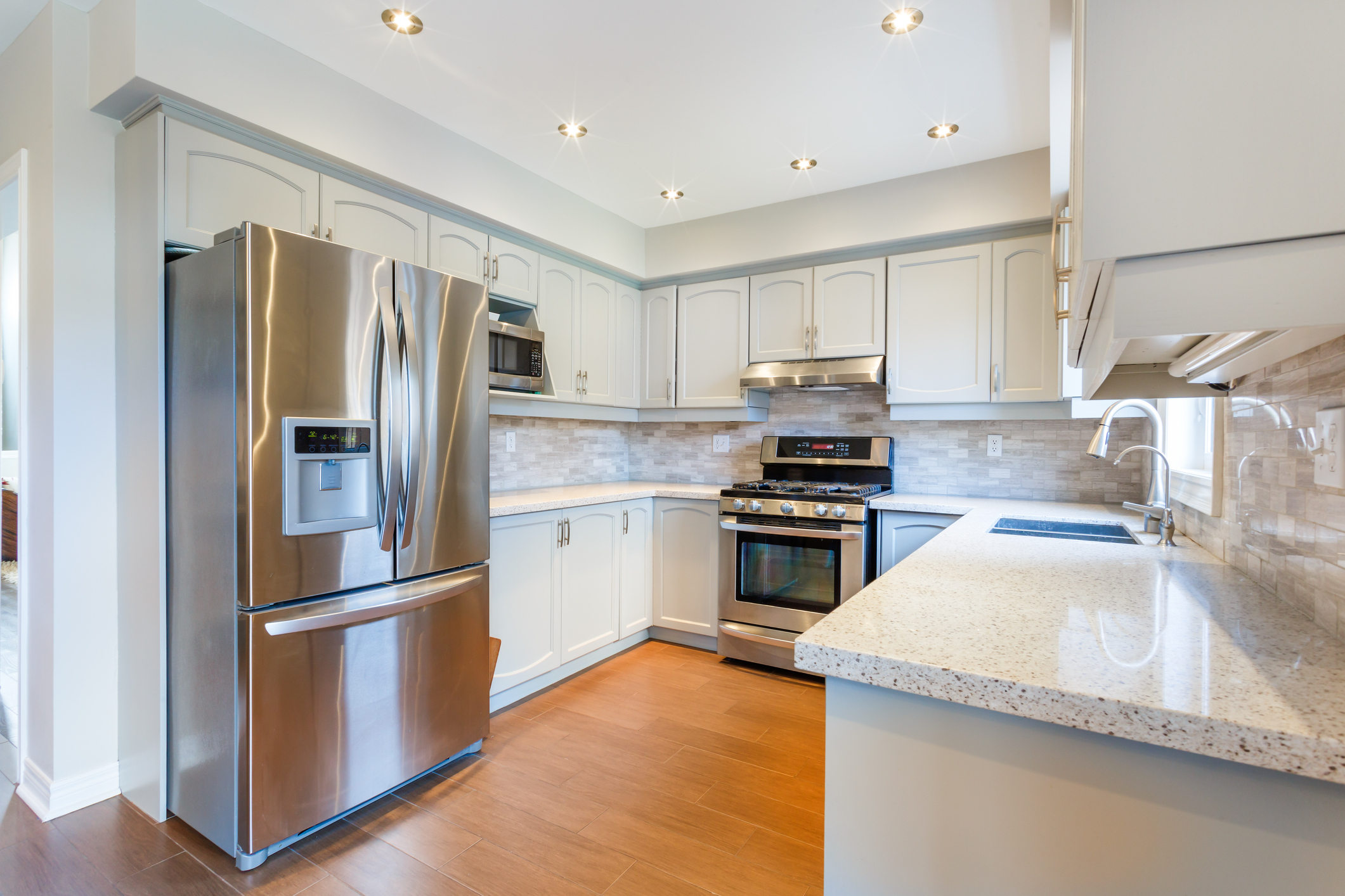 Modern kitchen with stainless steel appliances.